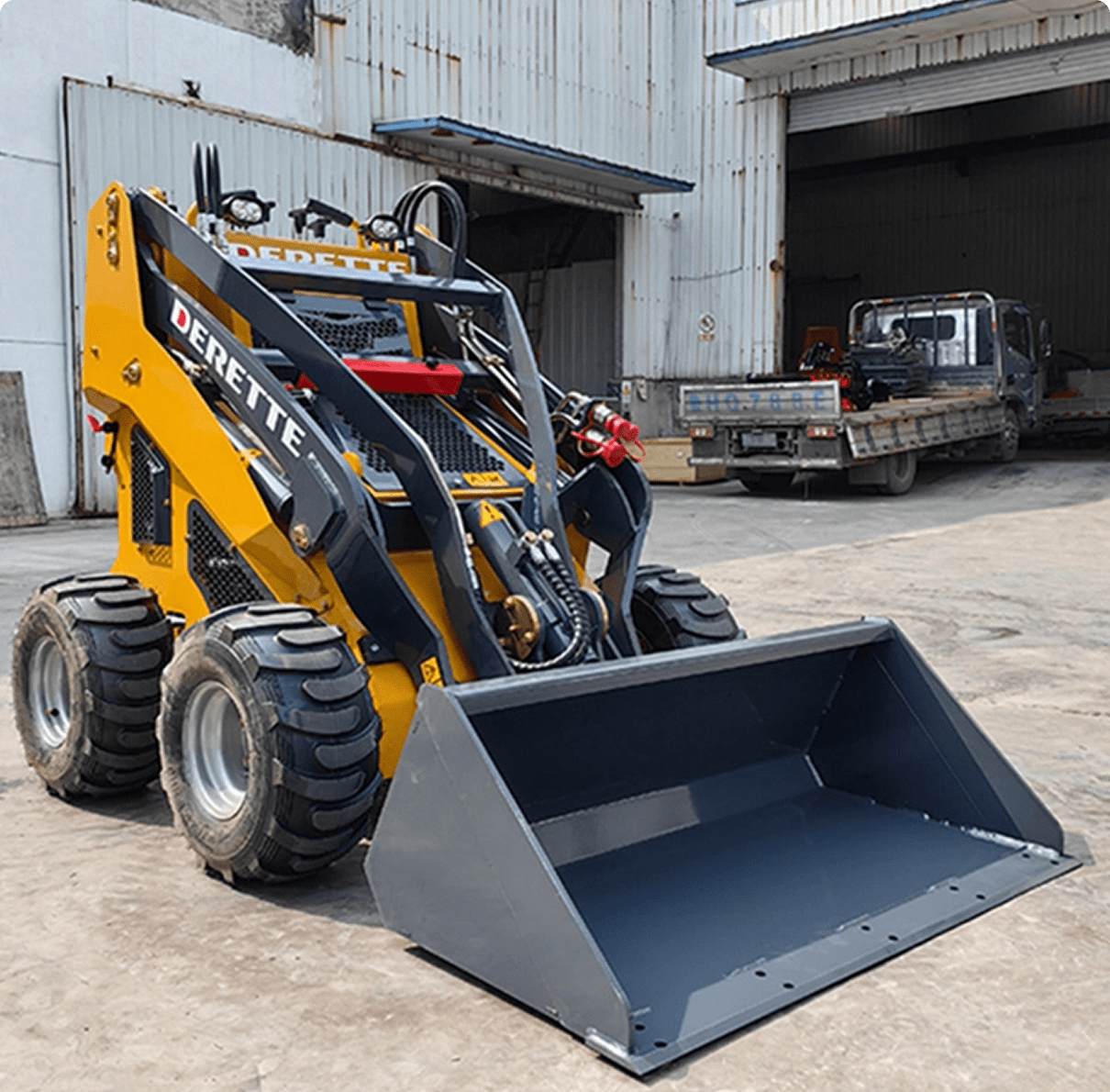 Compact construction vehicle with front bucket.